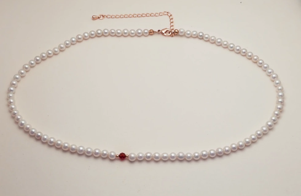 Actual freshwater pearl necklace with a red crystal and gold-tone extension chain
